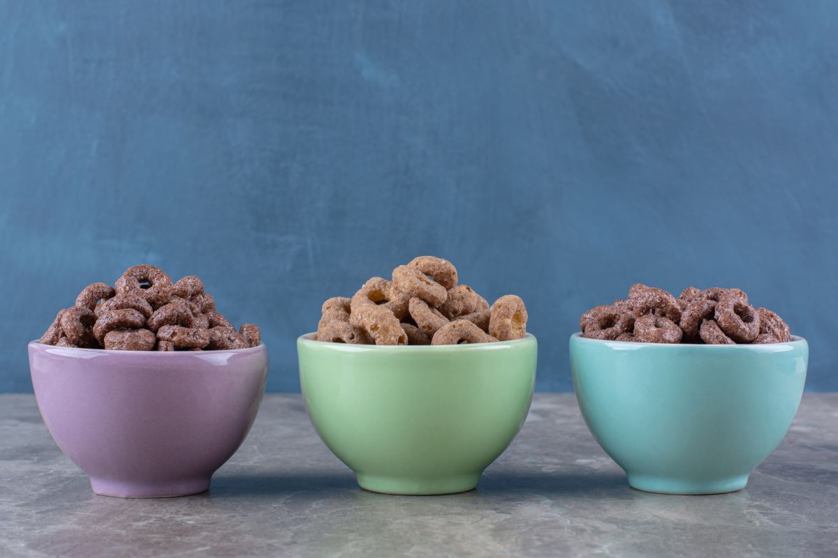 three-colorful-bowls-chocolate-cereal-rings-breakfast, three bowls full of food on the floor